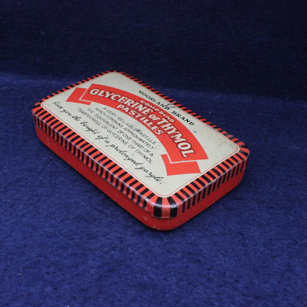 Vintage red and white box with text on a blue background