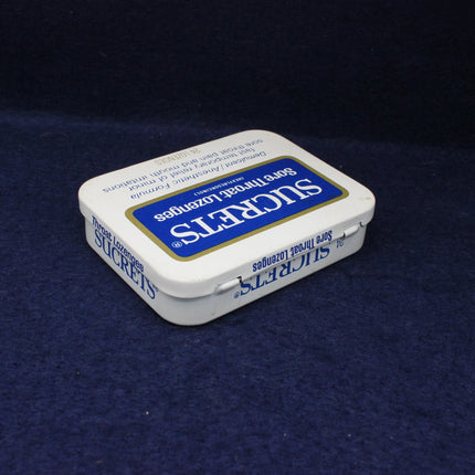 Sukretts candy tin on a dark blue background