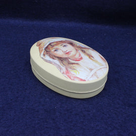 Round decorative box with a portrait on a blue background