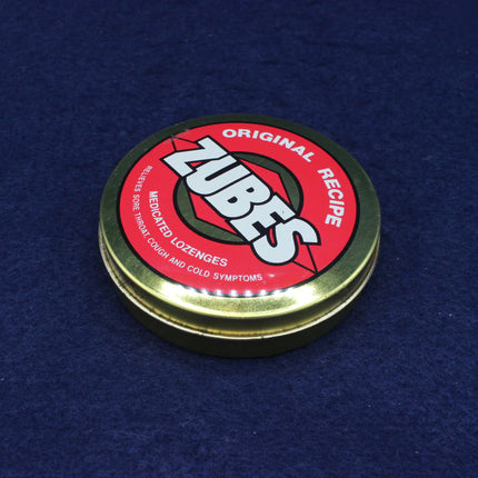 Zubes lozenge tin lid on a blue background