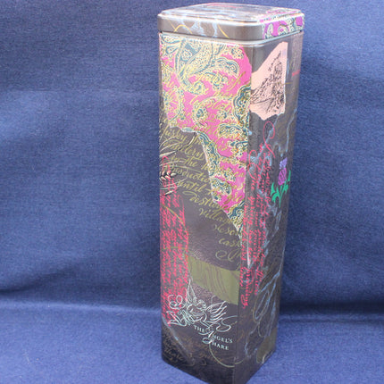 Decorative cylindrical box with floral patterns on a blue background