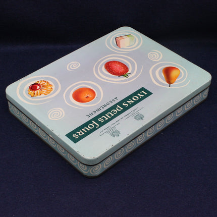 Tin box with fruit illustrations on a dark background