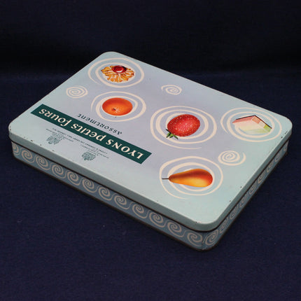 Rectangular tin box with fruit illustrations on a dark background