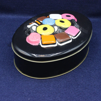 Black tin with colorful candy illustrations on a blue background