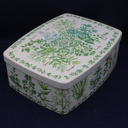 Rectangular tin box with herb design on a dark background