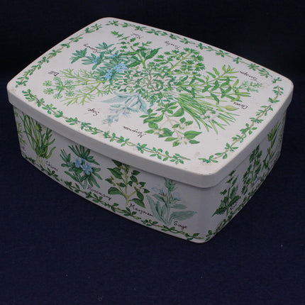 Rectangular tin box with botanical design on a dark background