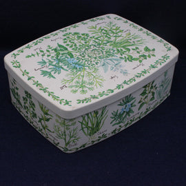 Rectangular tin box with botanical design on a dark background