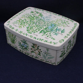 Rectangular tin box with herb illustrations on a dark background