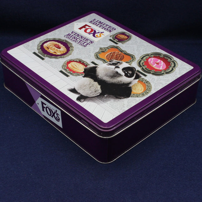Fox's biscuit tin with panda design on a dark blue background