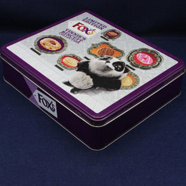 Fox's biscuit tin with panda design on a dark blue background