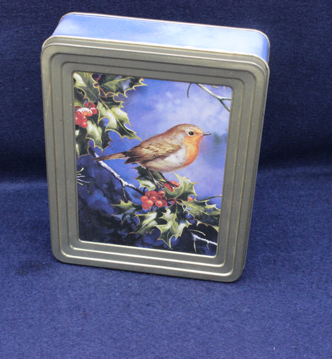 Metallic tin with a robin and holly design on a blue background