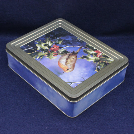 Rectangular tin box with a Christmas-themed design featuring a robin and holly on a blue background.