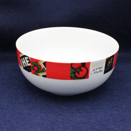 White bowl with a colorful band featuring text and graphics on a dark blue background