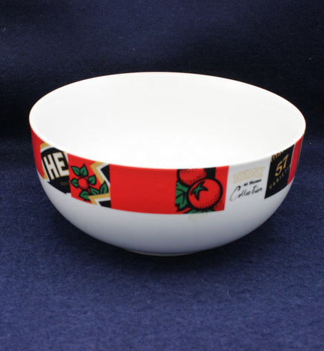 White bowl with a colorful band featuring text and graphics on a dark blue background