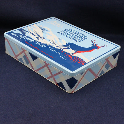 Side view of a biscuit tin with  stag animal on the lid