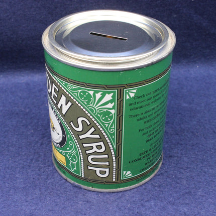 Green canister labeled 'Golden Syrup' with a metallic lid on a blue background