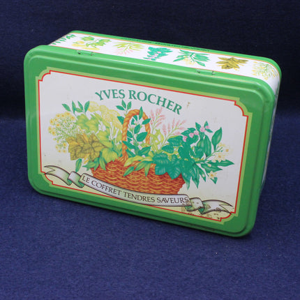Green tin box with Yves Rocher branding on a blue background