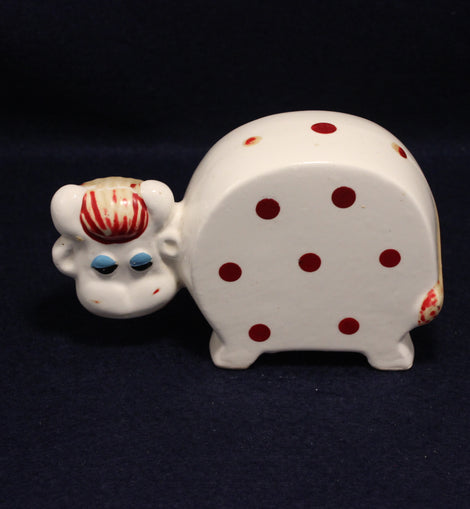Vintage Cow Money box on a dark blue backgtound