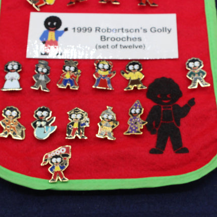 Set of Robertson's Golly Brooches on a red and green background with a label.