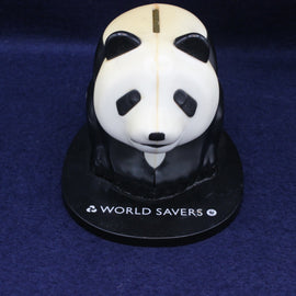Panda-shaped money box with 'World Savers' branding on a dark blue background