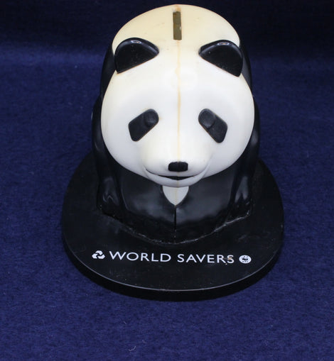 Panda-shaped money box with 'World Savers' branding on a dark blue background