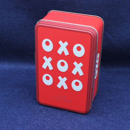 Red tin box with 'OXO' branding on a blue background