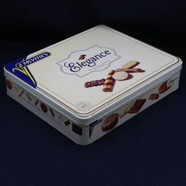 McVitie's Elegance cookie tin on a dark background