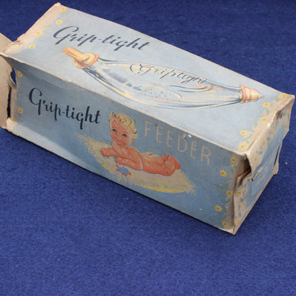 Vintage 'Grip-tight' feeder box with a baby illustration on a blue background