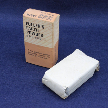 Box of Fuller's Earth Powder and a block of the powder on a blue background