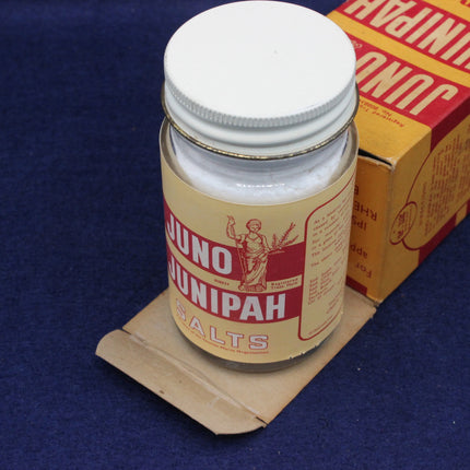 Juno Junipah Salts container with a cardboard box on a blue background