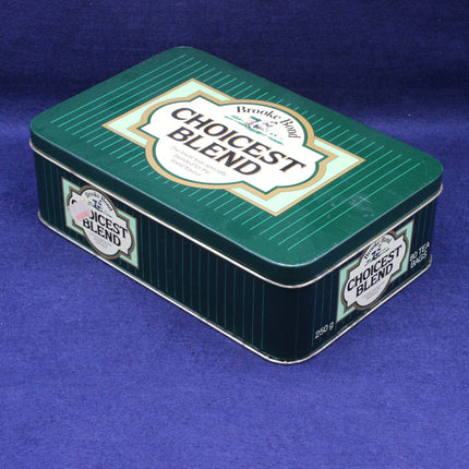 Dark green tea caddy picture with Brooke Bond tea branding on the lid