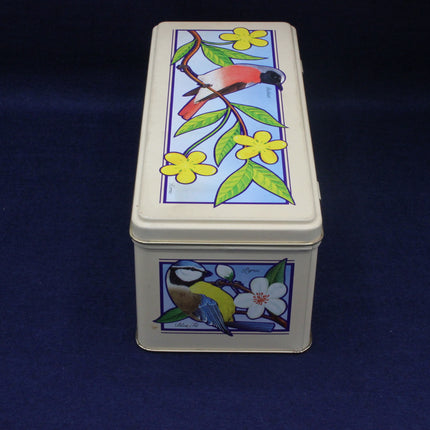 Rectangular tin box with bird and floral design on a dark blue background