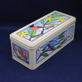 Rectangular tin box with bird and floral design on a blue background