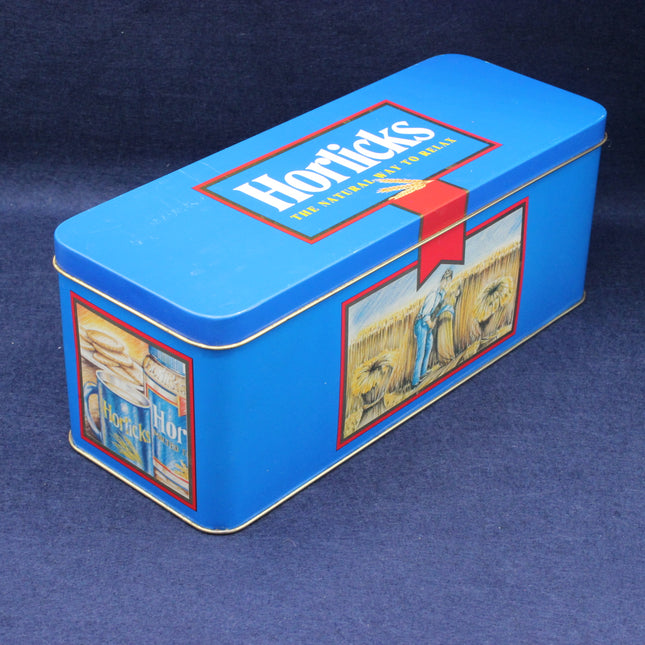 Blue tin box with 'Horlicks' branding on a dark blue background