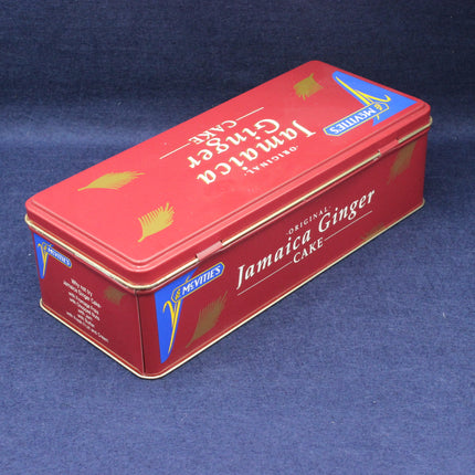 Red tin box of Jamaica Ginger Cake on a blue background