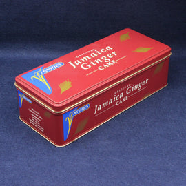 Red tin box of McVitie's Jamaica Ginger Cake on a blue background