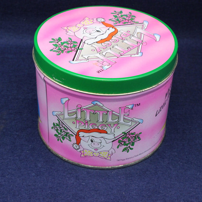Pink tin can with cartoon pig design on a blue background