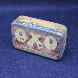 Vintage Oxo cube container on a blue background