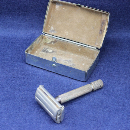 Vintage safety razor and open case on a blue background