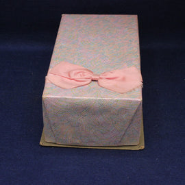 Rectangular gift box with a pink bow on a dark blue background