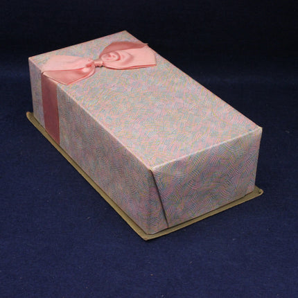 Gift box with a pink ribbon on a dark blue background