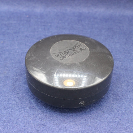 Black container with a visible brand logo on a blue background