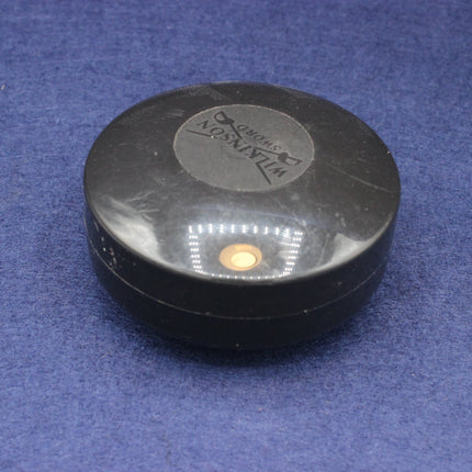 Black wilkinson sword container on a blue background