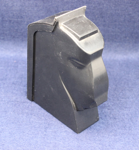 Black plastic component on a blue background