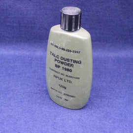 Bottle of talc dusting powder on a blue background
