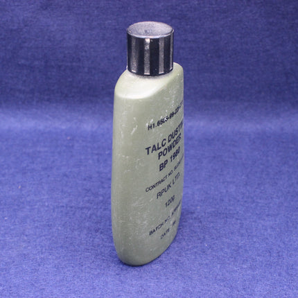 Talc dust powder bottle with silver cap on a blue background
