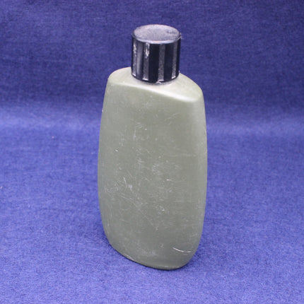 Green bottle with silver cap on a blue background