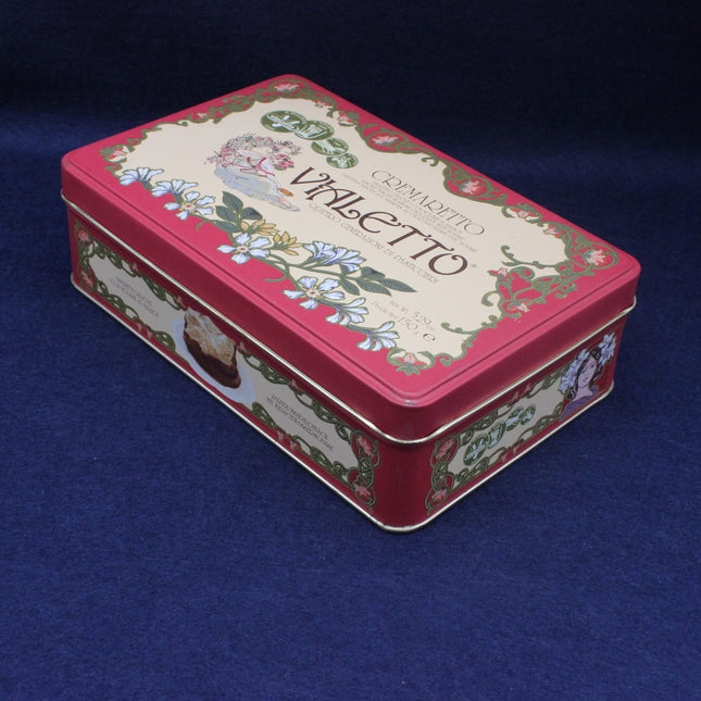 Decorative rectangular tin box with floral design and text on a blue background