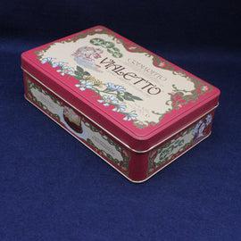 Decorative rectangular tin box with floral design and text on a blue background