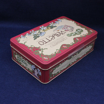 Decorative rectangular tin box with floral designs on a dark blue background